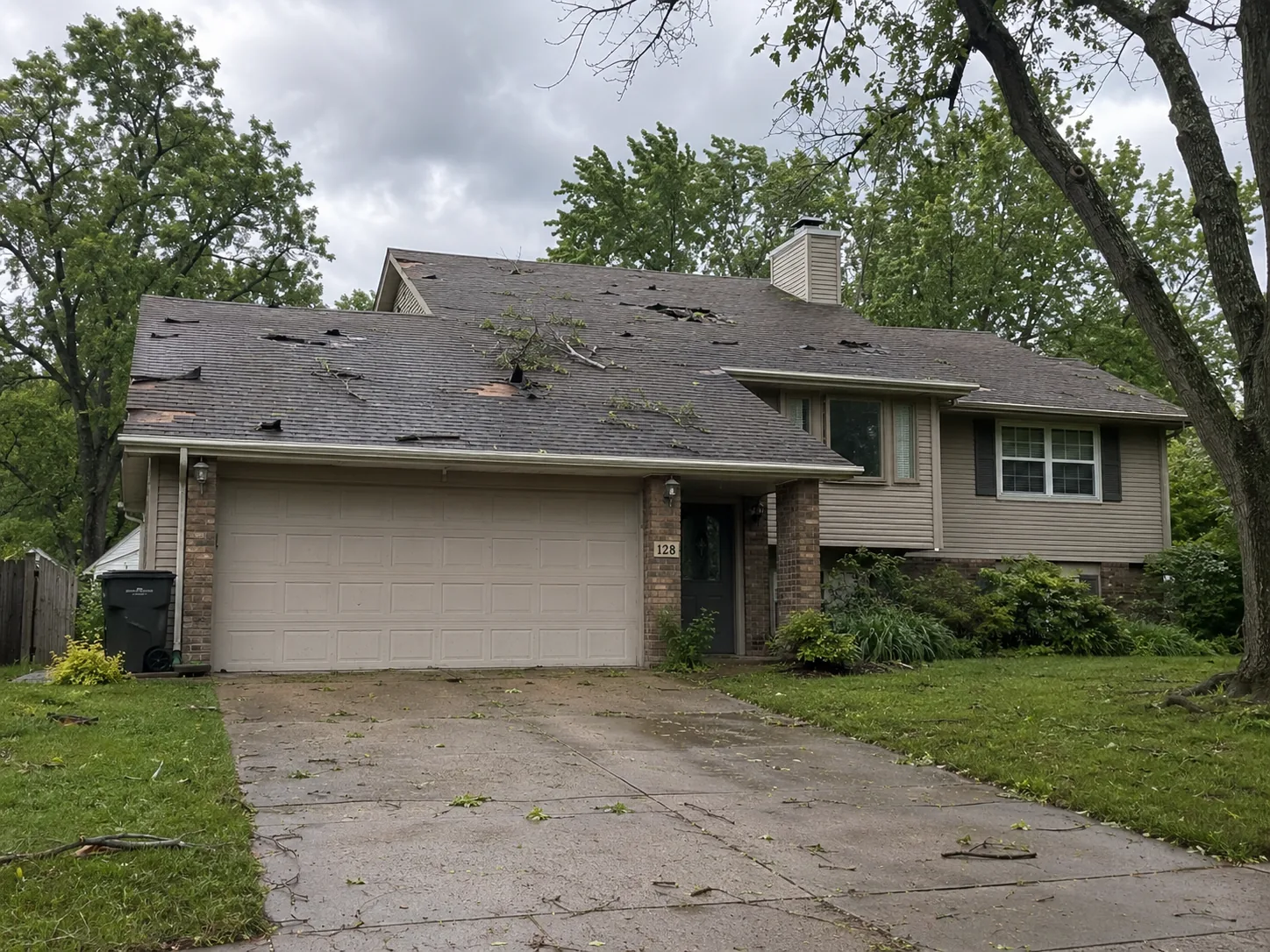 Wind-damaged roof with missing shingles after a storm