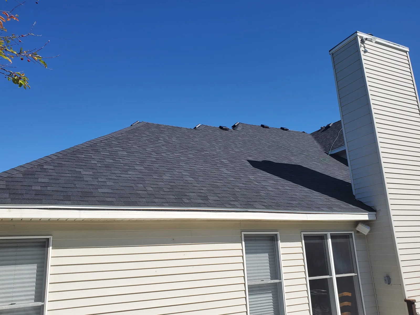 Completed asphalt shingle roof replacement with clean rooflines by RG Roofing & Exteriors