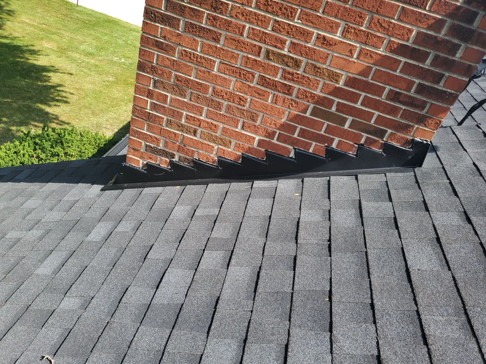 Completed roof flashing and chimney detail by RG Roofing & Exteriors